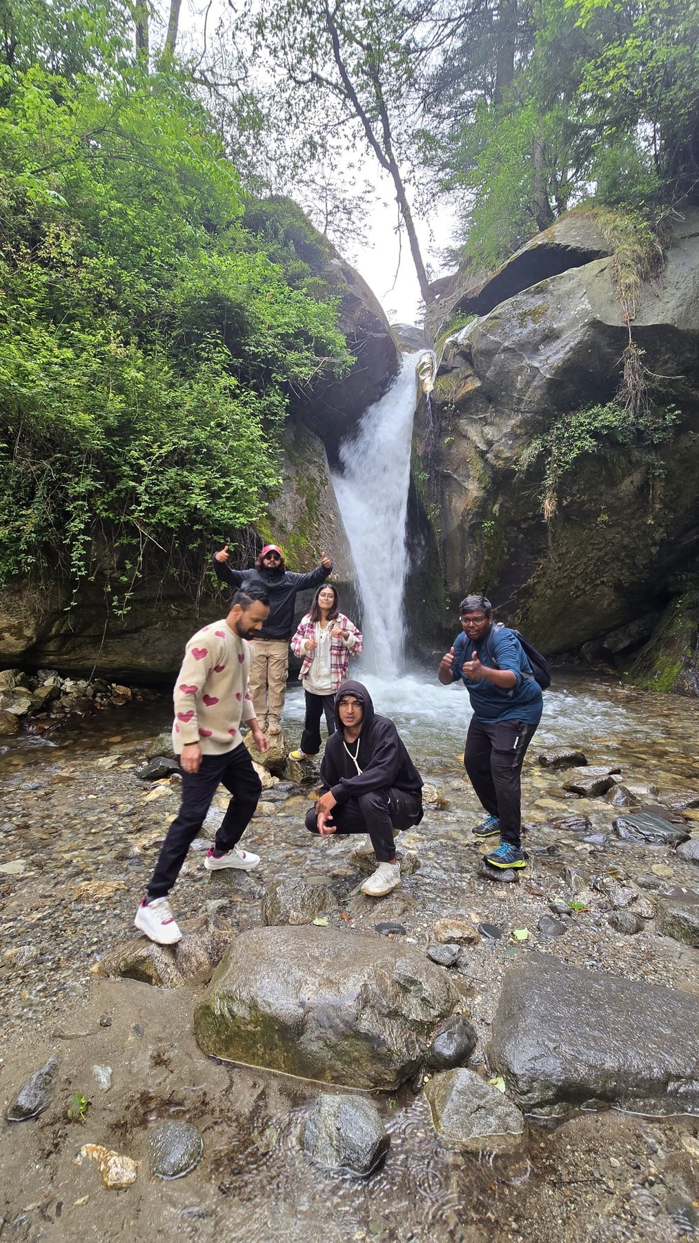 A group of Safar travellers reaching a waterfall near Manali