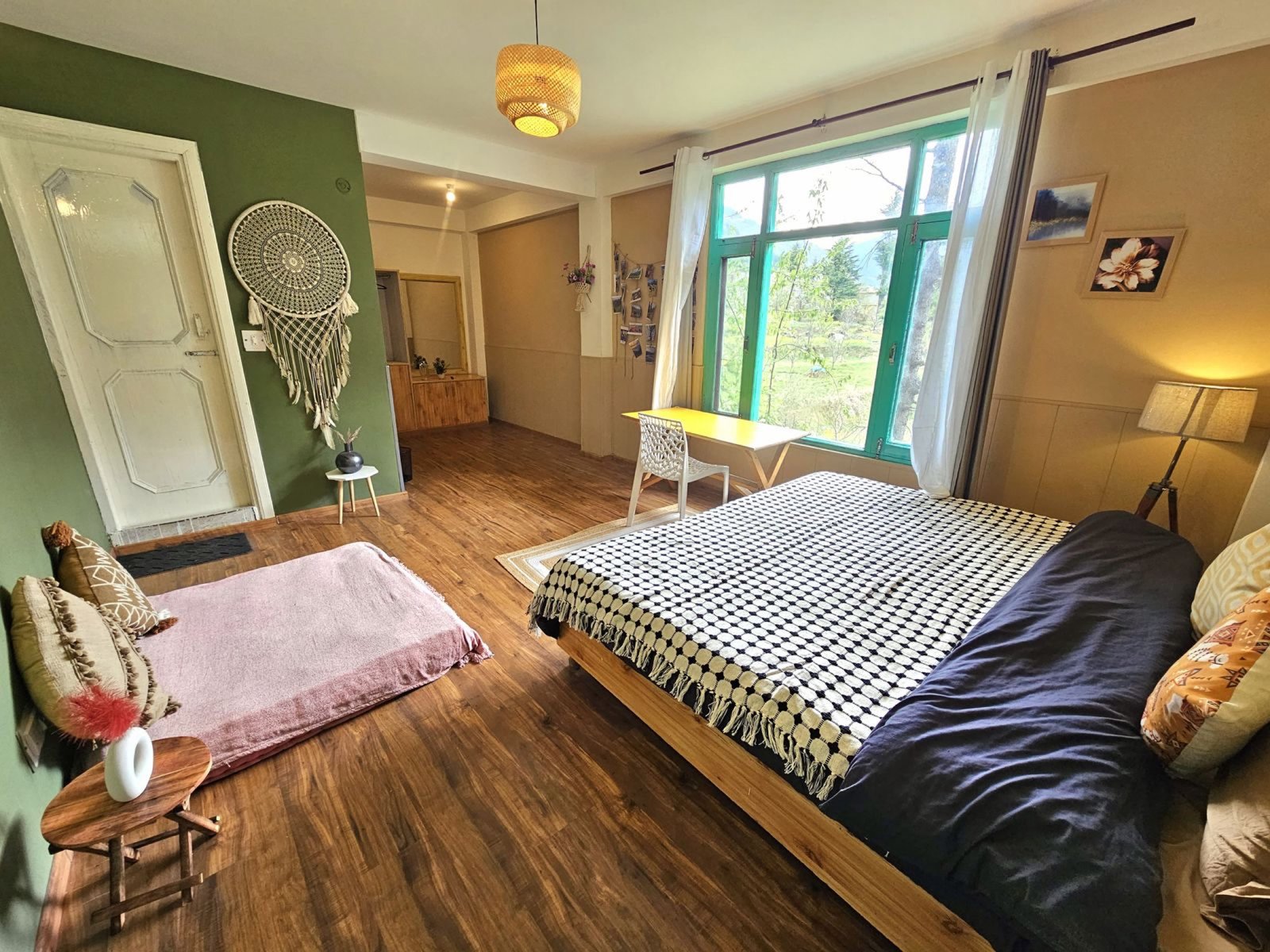 Safar Hostel Corner Room with double bed, seating and large windows
