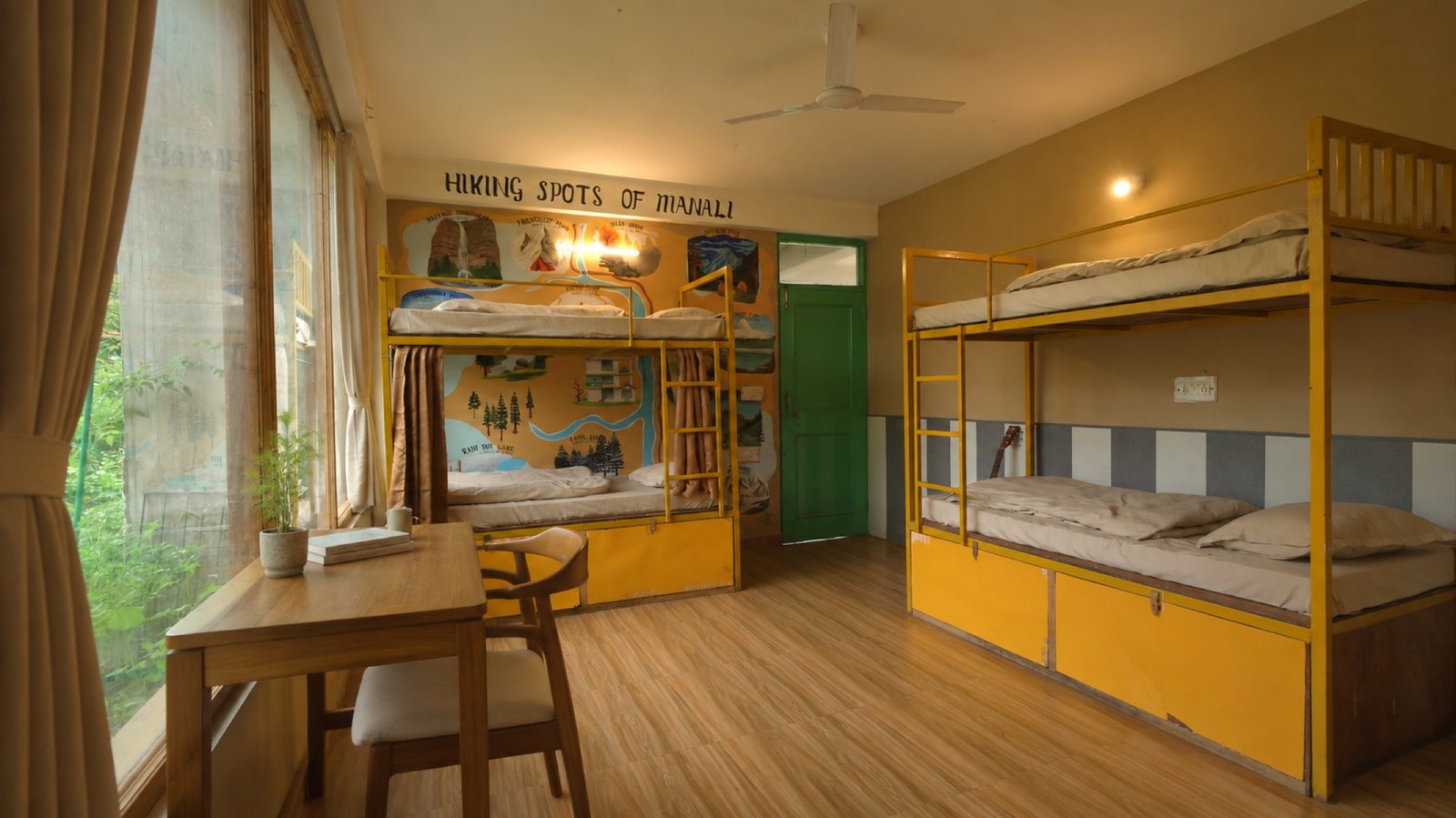 Safar Hostel four-bed dorm with yellow bunks, lockers and window desk