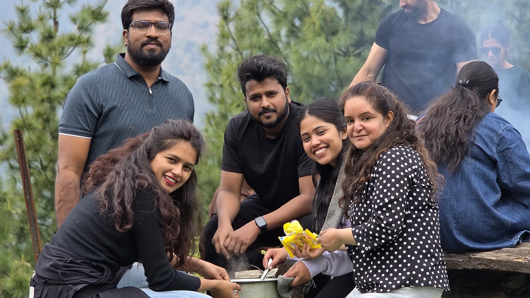 Safar travellers gathered around a shared outdoor cooking pot