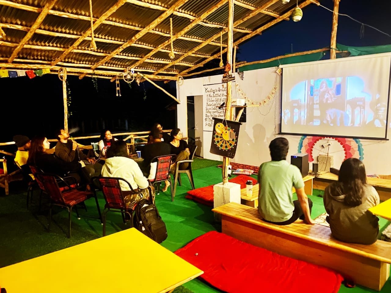 Guests watching a film in Safar's covered café